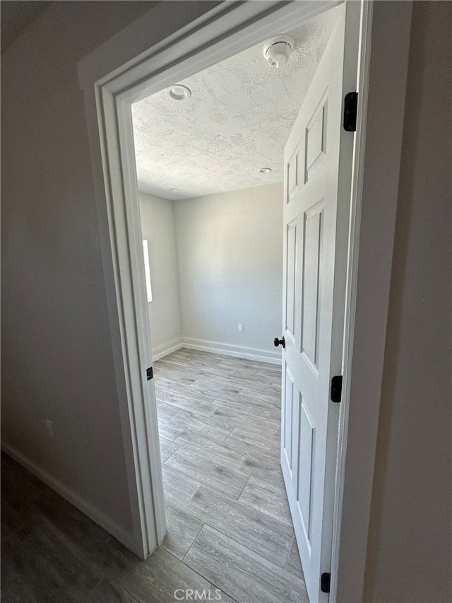 829 Foxworth Ave, La Puente, CA 91744 - corridor with a textured ceiling and wood finished floors
