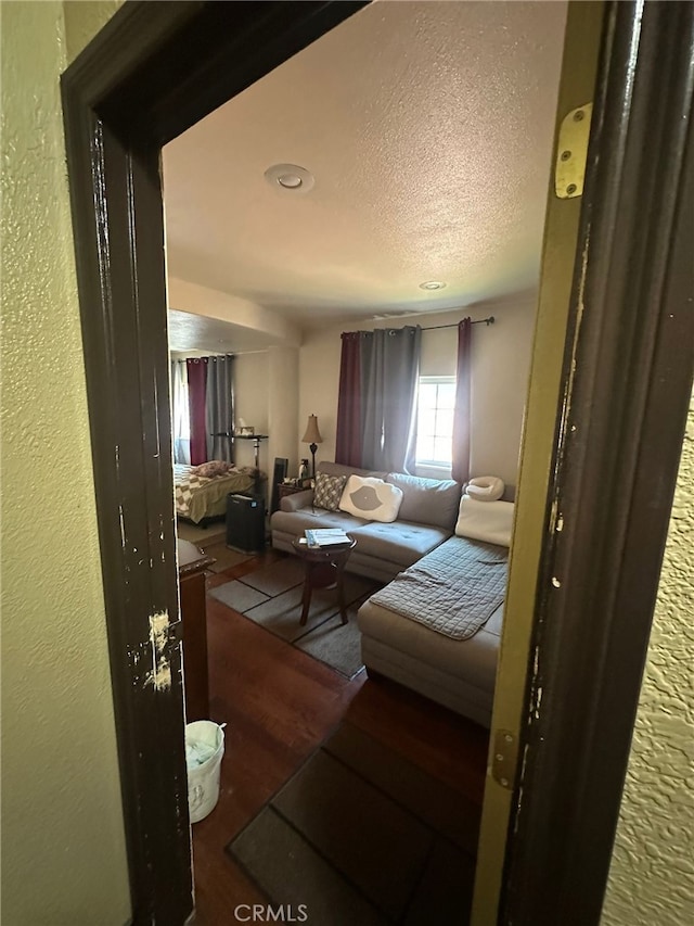 829 Foxworth Ave, La Puente, CA 91744 - living area featuring wood finished floors, a textured ceiling, and a textured wall