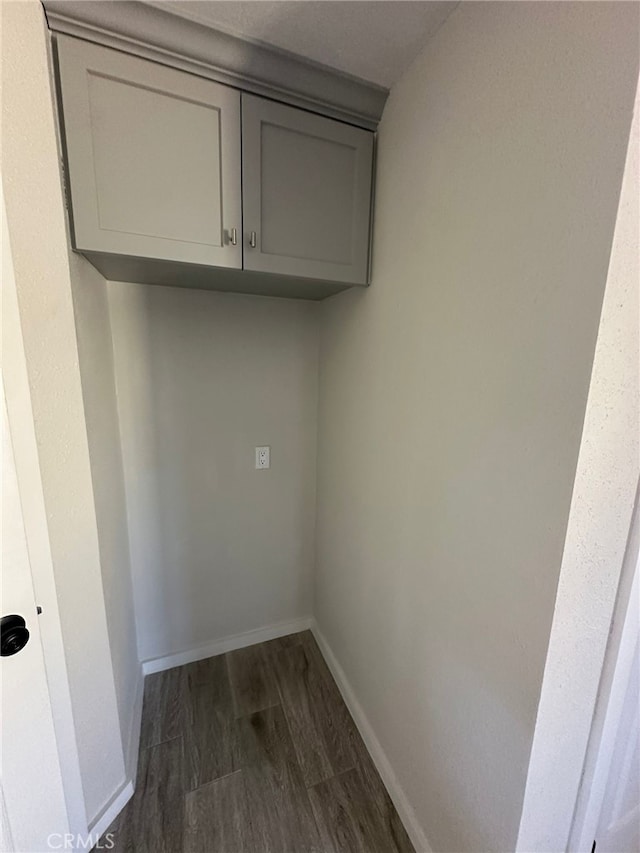 829 Foxworth Ave, La Puente, CA 91744 - laundry room featuring dark wood-style flooring and baseboards
