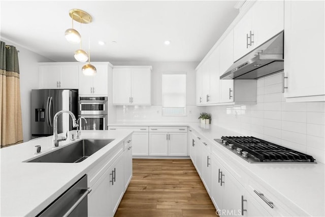 16526 Trailblazer Ave, Chino, CA 91708 - kitchen with under cabinet range hood, appliances with stainless steel finishes, light countertops, white cabinets, and tasteful backsplash