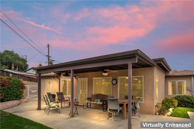 433 E Mason St, Azusa, CA 91702 - back of house at dusk featuring ceiling fan, stucco siding, a patio, and outdoor dining space