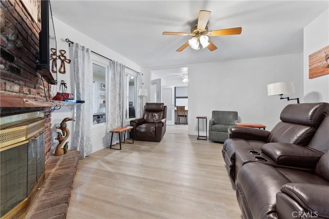 433 E Mason St, Azusa, CA 91702 - living area with a ceiling fan, a fireplace, and light wood-style floors