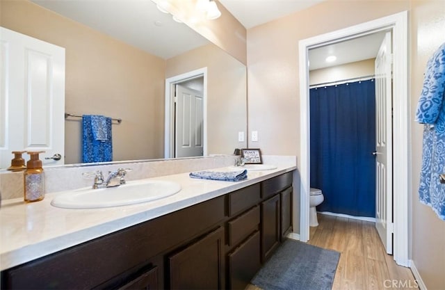 17995 Lacebark Ct, San Bernardino, CA 92407 - bathroom featuring wood finished floors, double vanity, and a shower with shower curtain
