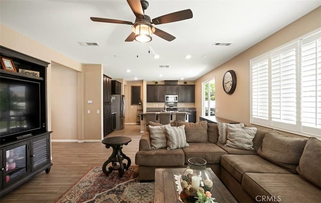 17995 Lacebark Ct, San Bernardino, CA 92407 - living room featuring light wood finished floors, a ceiling fan, and recessed lighting