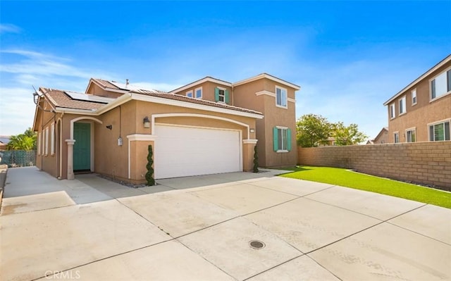 17995 Lacebark Ct, San Bernardino, CA 92407 - view of front of house with roof mounted solar panels, concrete driveway, stucco siding, and a tiled roof