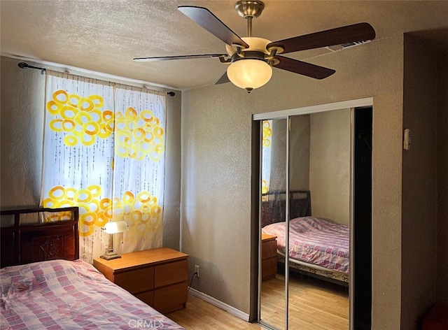 7513 Marsh Ave, Rosemead, CA 91770 - bedroom with light wood finished floors, a textured wall, a closet, a textured ceiling, and baseboards