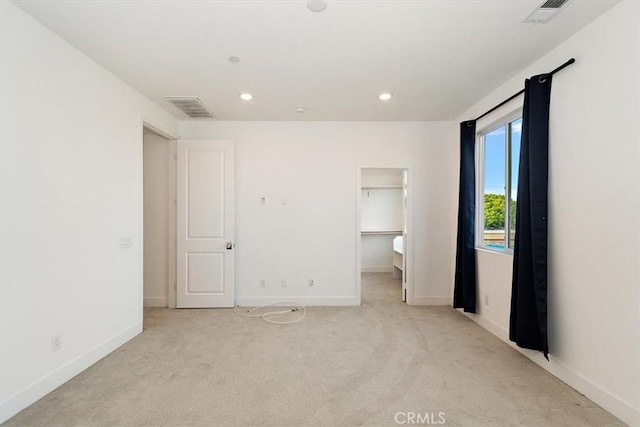 2750 182nd St Unit 112, Torrance, CA 90504 - unfurnished bedroom with light carpet, a walk in closet, baseboards, and recessed lighting