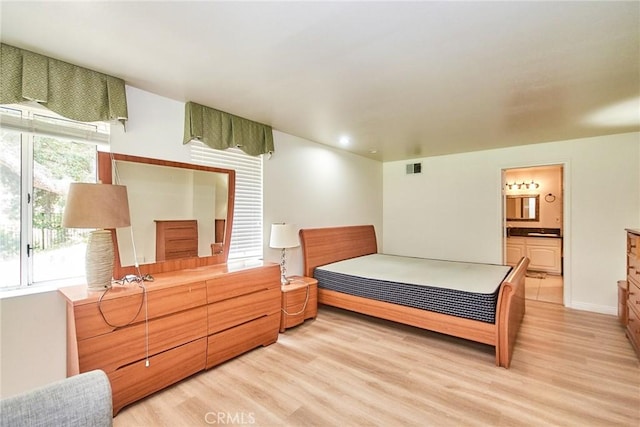 1089 Village Dr, Chino Hills, CA 91709 - bedroom featuring light wood finished floors, ensuite bath, and baseboards
