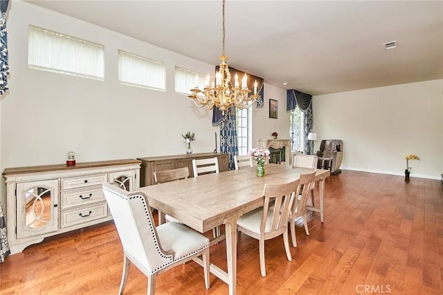 1089 Village Dr, Chino Hills, CA 91709 - dining area featuring a chandelier, light wood-style flooring, and baseboards