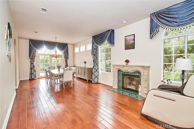 1089 Village Dr, Chino Hills, CA 91709 - dining room with a chandelier, wood finished floors, baseboards, and a fireplace