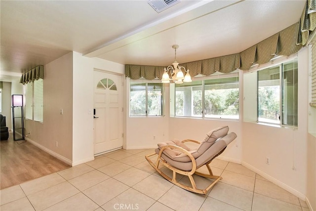 1089 Village Dr, Chino Hills, CA 91709 - living area with light tile patterned floors, a chandelier, and baseboards