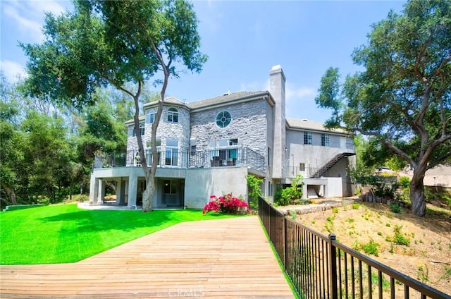 1089 Village Dr, Chino Hills, CA 91709 - back of house with stone siding, a chimney, a lawn, and stucco siding