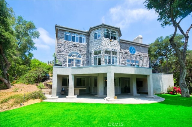 1089 Village Dr, Chino Hills, CA 91709 - back of house with a balcony, a patio, stone siding, and a yard