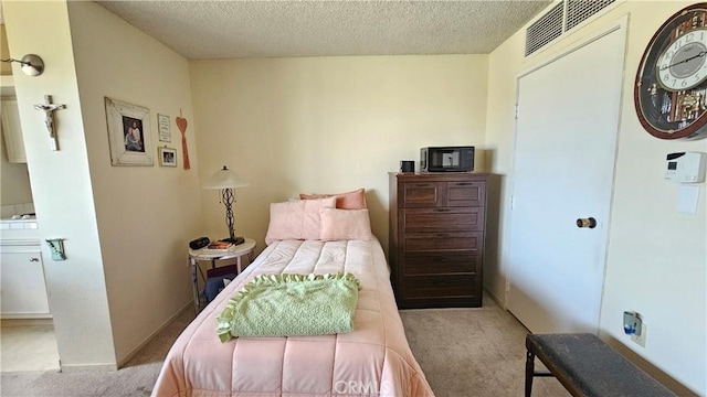 24055 Paseo Del Lago Unit 1012, Laguna Woods, CA 92637 - bedroom with carpet flooring and a textured ceiling
