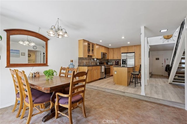 10161 Larwin Ave Unit 3, Chatsworth, CA 91311 - dining area featuring a chandelier, stairway, recessed lighting, and light tile patterned floors