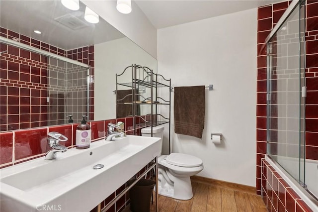 10161 Larwin Ave Unit 3, Chatsworth, CA 91311 - bathroom with toilet, wood finished floors, tiled shower / bath, baseboards, and vanity