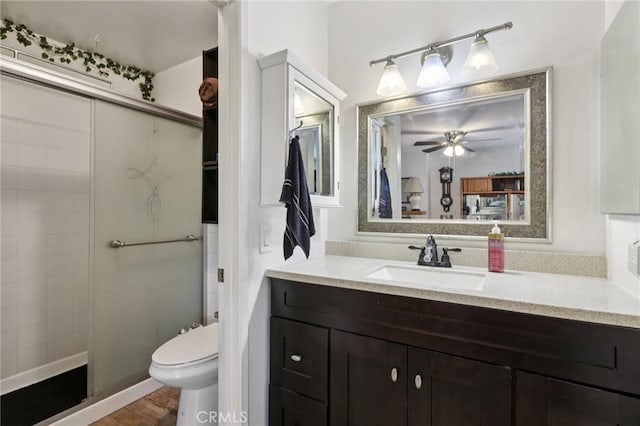 10161 Larwin Ave Unit 3, Chatsworth, CA 91311 - full bath featuring vanity, a ceiling fan, toilet, a tile shower, and wood finished floors