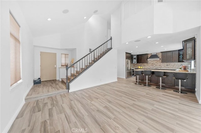 10991 Countryview Dr, Rancho Cucamonga, CA 91730 - living area featuring a high ceiling, stairs, light wood-style floors, baseboards, and recessed lighting