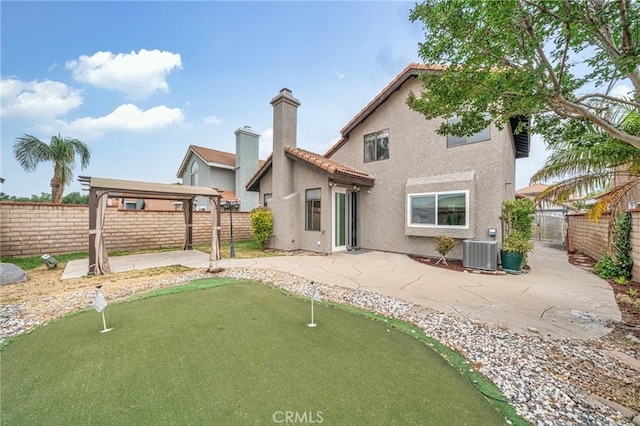 10991 Countryview Dr, Rancho Cucamonga, CA 91730 - rear view of house with central AC, a putting green, stucco siding, a patio area, and a fenced backyard