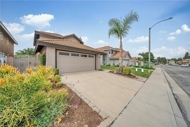 10991 Countryview Dr, Rancho Cucamonga, CA 91730 - view of front facade featuring stucco siding, a tile roof, driveway, a gate, and a garage