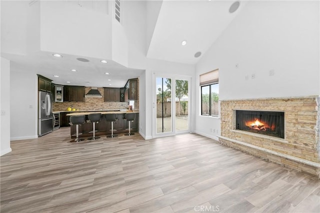 10991 Countryview Dr, Rancho Cucamonga, CA 91730 - living area featuring high vaulted ceiling, baseboards, light wood finished floors, recessed lighting, and a stone fireplace