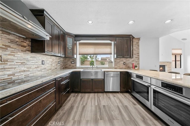 10991 Countryview Dr, Rancho Cucamonga, CA 91730 - kitchen with stainless steel appliances, extractor fan, a sink, light wood finished floors, and recessed lighting