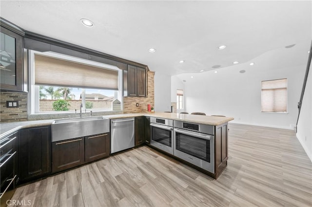 10991 Countryview Dr, Rancho Cucamonga, CA 91730 - kitchen featuring appliances with stainless steel finishes, decorative backsplash, recessed lighting, light wood finished floors, and light countertops