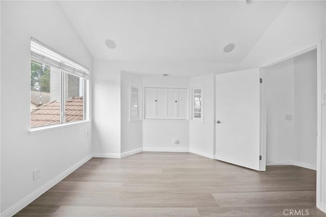 10991 Countryview Dr, Rancho Cucamonga, CA 91730 - spare room featuring vaulted ceiling, wood finished floors, and baseboards
