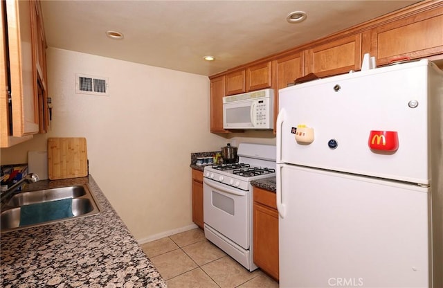1313 Massachusetts Ave Unit 206, Riverside, CA 92507 - kitchen featuring white appliances, a sink, dark countertops, light tile patterned floors, and baseboards
