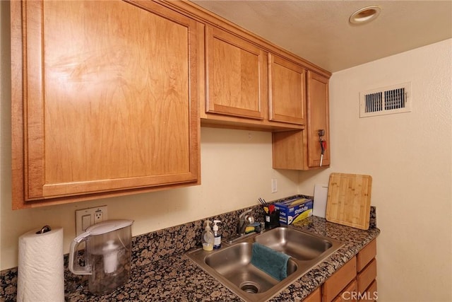 1313 Massachusetts Ave Unit 206, Riverside, CA 92507 - kitchen featuring a sink, dark countertops, and brown cabinets
