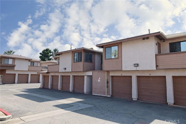 1313 Massachusetts Ave Unit 206, Riverside, CA 92507 - view of front of house featuring stucco siding and community garages
