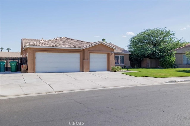 47734 Mirage Way, Indio, CA 92201 - ranch-style home featuring an attached garage, a tile roof, stucco siding, and driveway