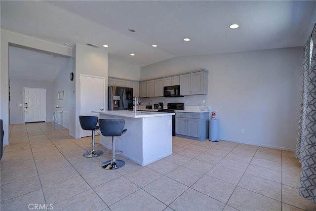 47734 Mirage Way, Indio, CA 92201 - kitchen featuring refrigerator with ice dispenser, black microwave, lofted ceiling, gray cabinets, and stove