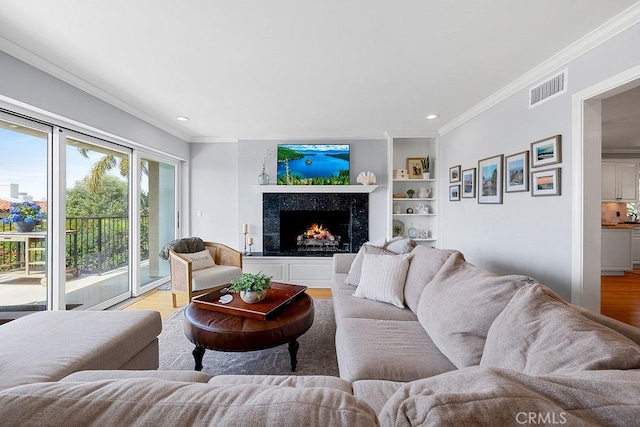 1609 Via Montemar, Palos Verdes Estates, CA 90274 - living area featuring light wood-style floors, ornamental molding, recessed lighting, a high end fireplace, and built in features