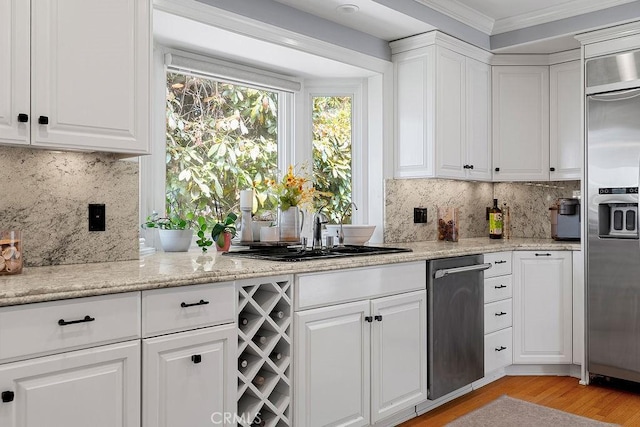 1609 Via Montemar, Palos Verdes Estates, CA 90274 - kitchen with appliances with stainless steel finishes, white cabinets, light wood-style flooring, decorative backsplash, and crown molding