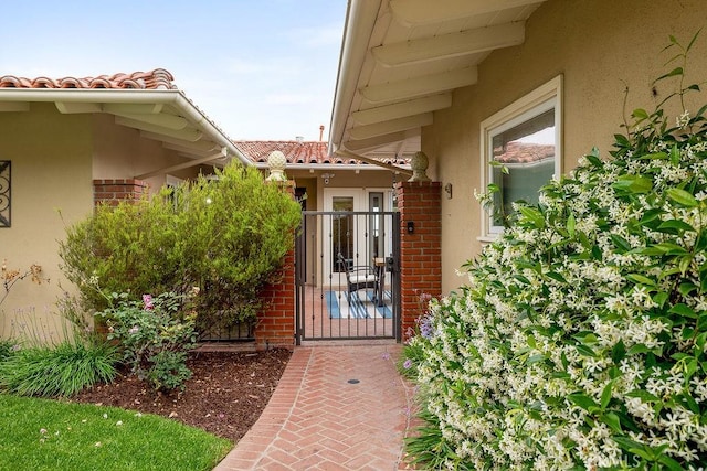 1609 Via Montemar, Palos Verdes Estates, CA 90274 - property entrance with stucco siding, a gate, a tile roof, and brick siding