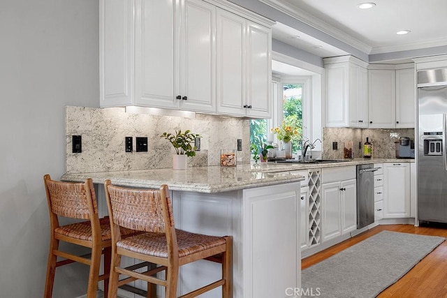 1609 Via Montemar, Palos Verdes Estates, CA 90274 - kitchen with stainless steel built in refrigerator, white cabinetry, light wood-type flooring, ornamental molding, and recessed lighting