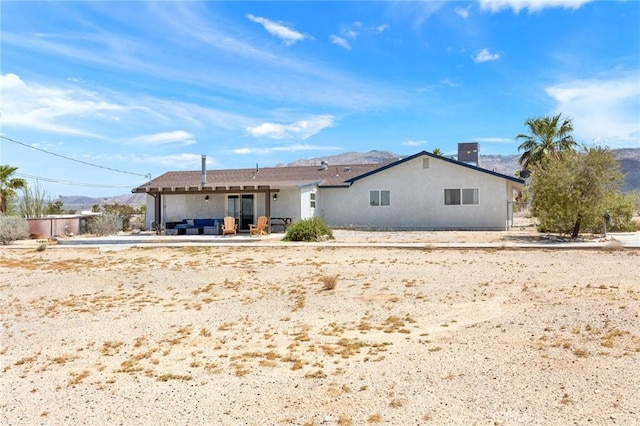 72726 Desert Trail Dr Unit 29, Palms, CA 92277 - back of house with a patio area, stucco siding, and a mountain view