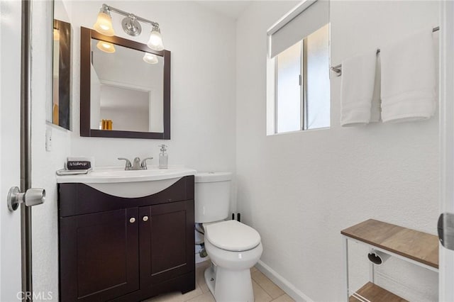 72726 Desert Trail Dr Unit 29, Palms, CA 92277 - half bath with vanity, toilet, baseboards, and tile patterned floors