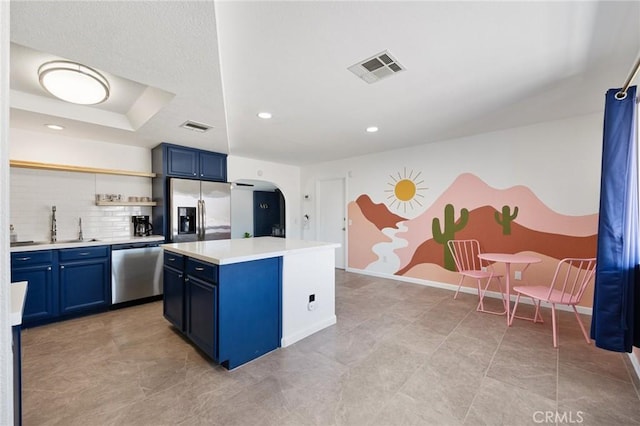 72726 Desert Trail Dr Unit 29, Palms, CA 92277 - kitchen featuring appliances with stainless steel finishes, blue cabinets, arched walkways, open shelves, and light countertops
