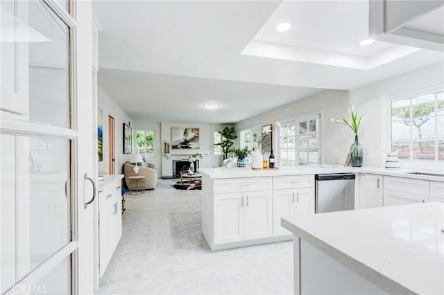 1717 Morning Sun Ave, Walnut, CA 91789 - kitchen with dishwasher, a brick fireplace, white cabinetry, open floor plan, and a peninsula