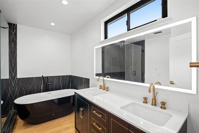 4801 Heaven Ave, Woodland Hills, CA 91364 - full bath with a soaking tub, a stall shower, wood finished floors, double vanity, and recessed lighting