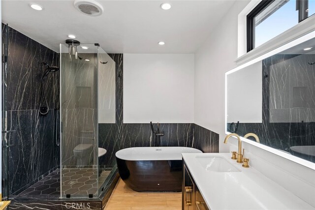 4801 Heaven Ave, Woodland Hills, CA 91364 - bathroom featuring tile walls, a marble finish shower, vanity, a soaking tub, and recessed lighting