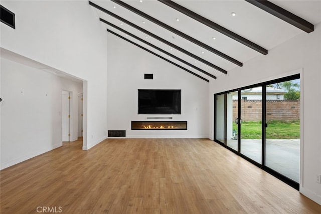 4801 Heaven Ave, Woodland Hills, CA 91364 - unfurnished living room with beam ceiling, high vaulted ceiling, a glass covered fireplace, light wood-type flooring, and recessed lighting