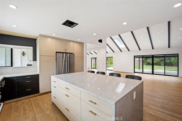 4801 Heaven Ave, Woodland Hills, CA 91364 - kitchen with stainless steel fridge, modern cabinets, a center island, open floor plan, and lofted ceiling