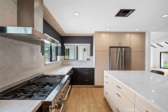 4801 Heaven Ave, Woodland Hills, CA 91364 - kitchen with wall chimney range hood, stainless steel appliances, light wood-type flooring, light stone countertops, and modern cabinets