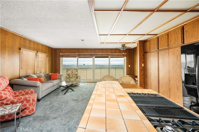1207 Seal Way, Seal Beach, CA 90740 - living area featuring wood walls, carpet floors, and ceiling fan
