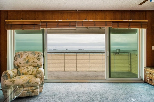 1207 Seal Way, Seal Beach, CA 90740 - entryway featuring carpet, a textured ceiling, wood walls, and a ceiling fan