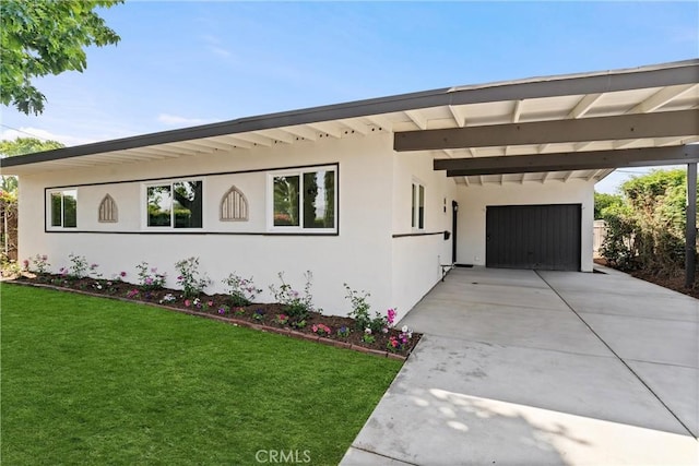 17924 E Kelby St, Covina, CA 91722 - view of front of property featuring an attached carport, concrete driveway, a front yard, and stucco siding