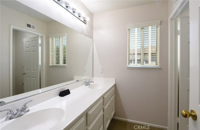 178 Grapevine Dr, Corona, CA 92882 - bathroom featuring plenty of natural light, double vanity, and baseboards